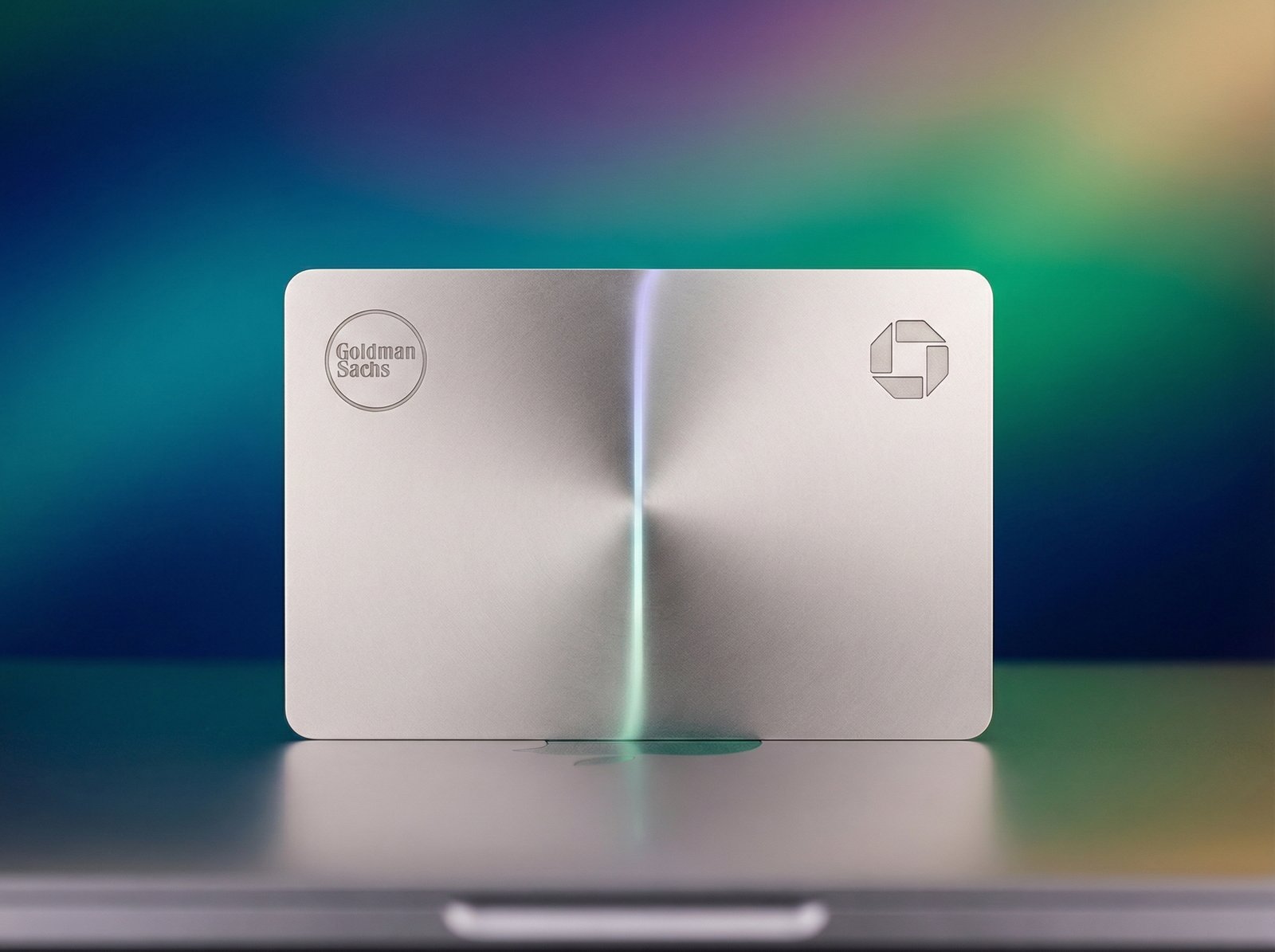 An Apple Card with a subtle Goldman Sachs logo on one side and a JPMorgan Chase logo on the other, symbolizing a transition. The background is a gradient of modern financial colors. Aspect ratio 4:3, no visible text.