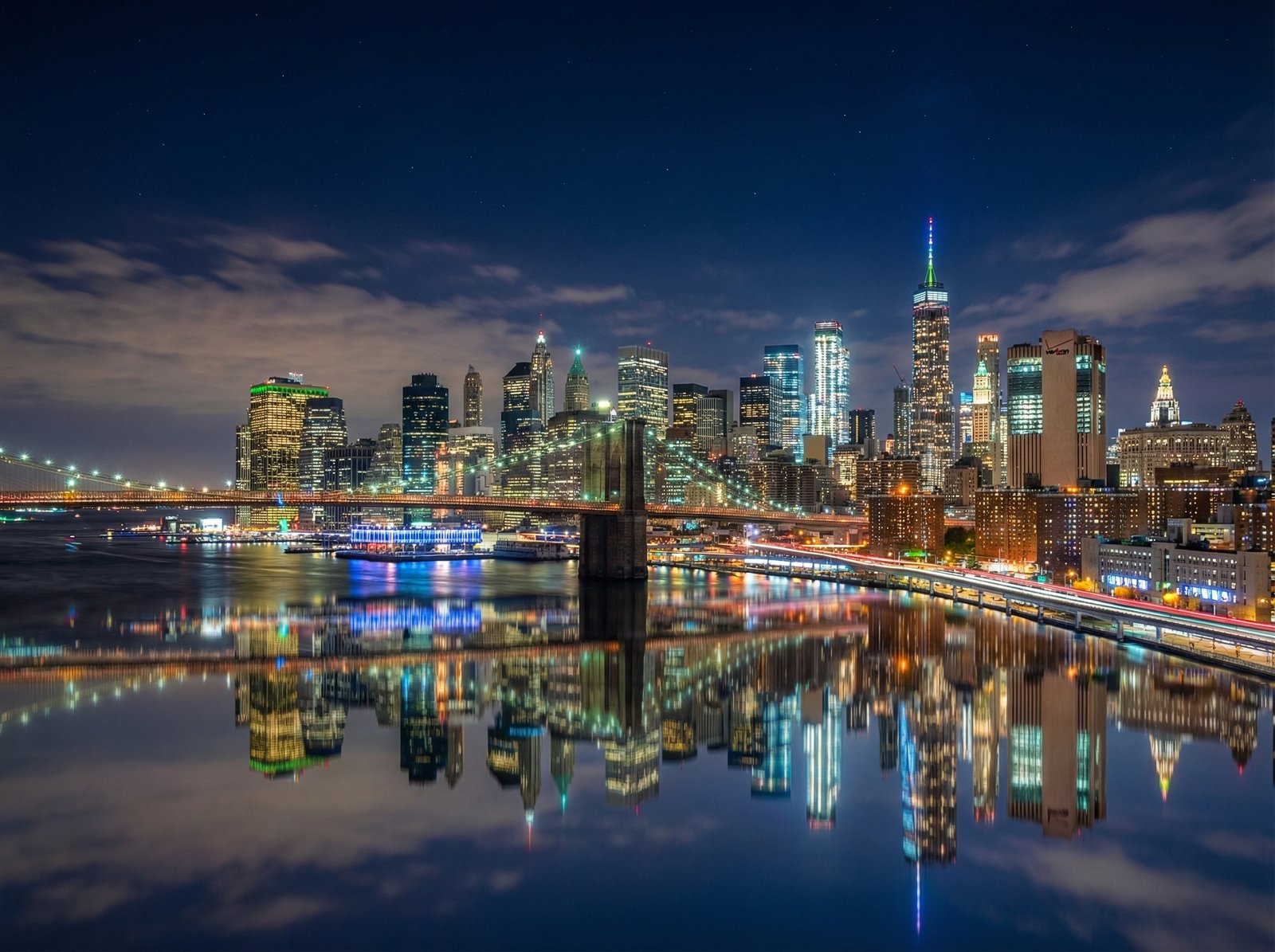 A stunning night cityscape captured with extreme detail, vibrant city lights reflecting on water, no grain, high dynamic range, hyper realistic, 4:3 aspect ratio, no text