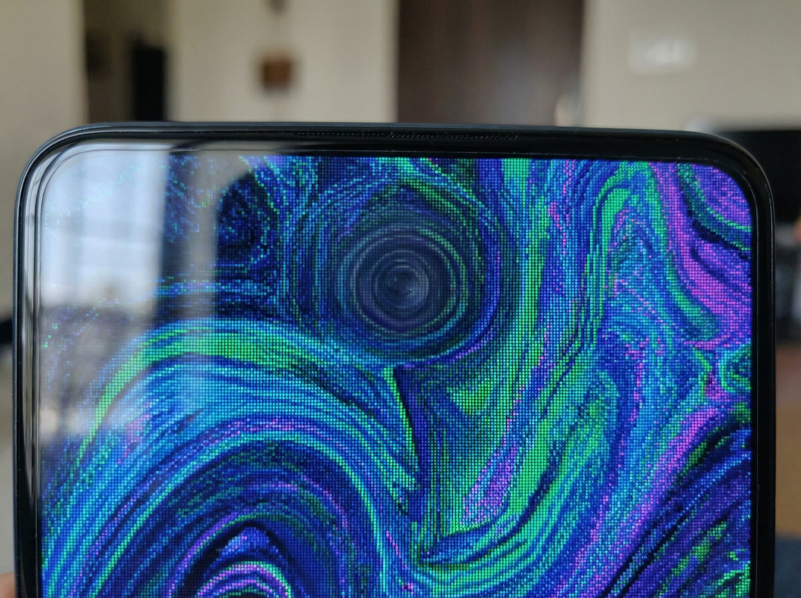 Close up of the top part of a smartphone screen, a lens is faintly visible under the pixels, no notch or punch hole, vibrant colors on the screen, realistic photography, 4:3 aspect ratio, no visible text