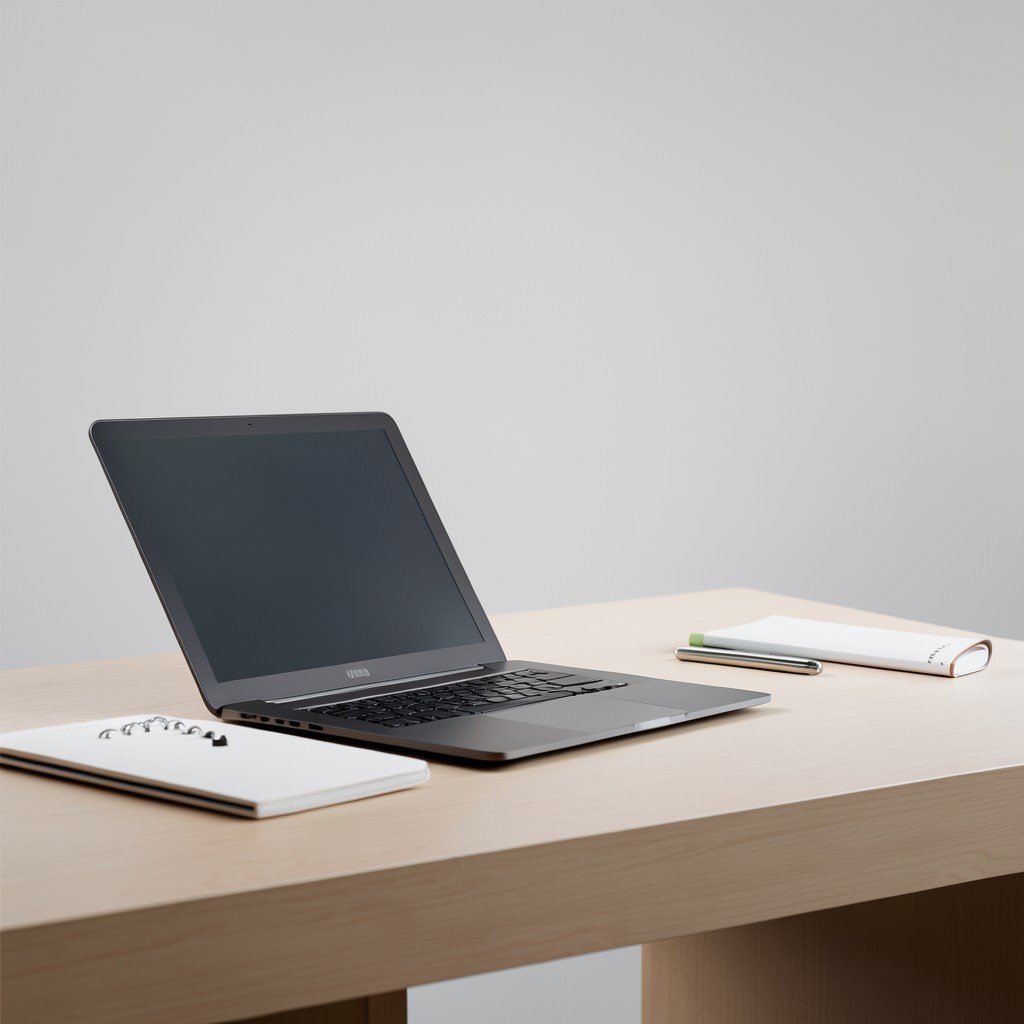 Professional working environment with a powerful laptop, minimalist desk setup, soft studio lighting, high resolution, 4:3
